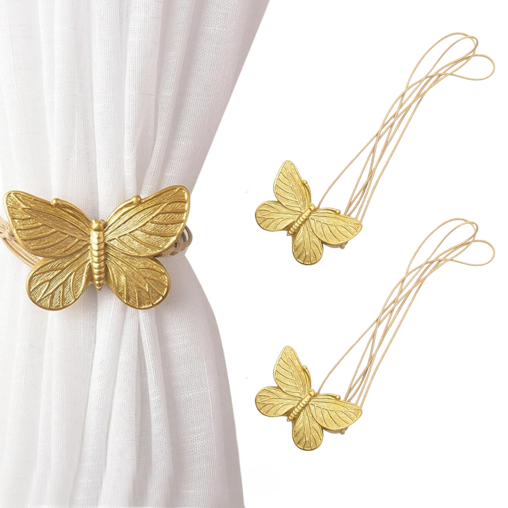 Gold butterfly-shaped curtain tiebacks on a white curtain