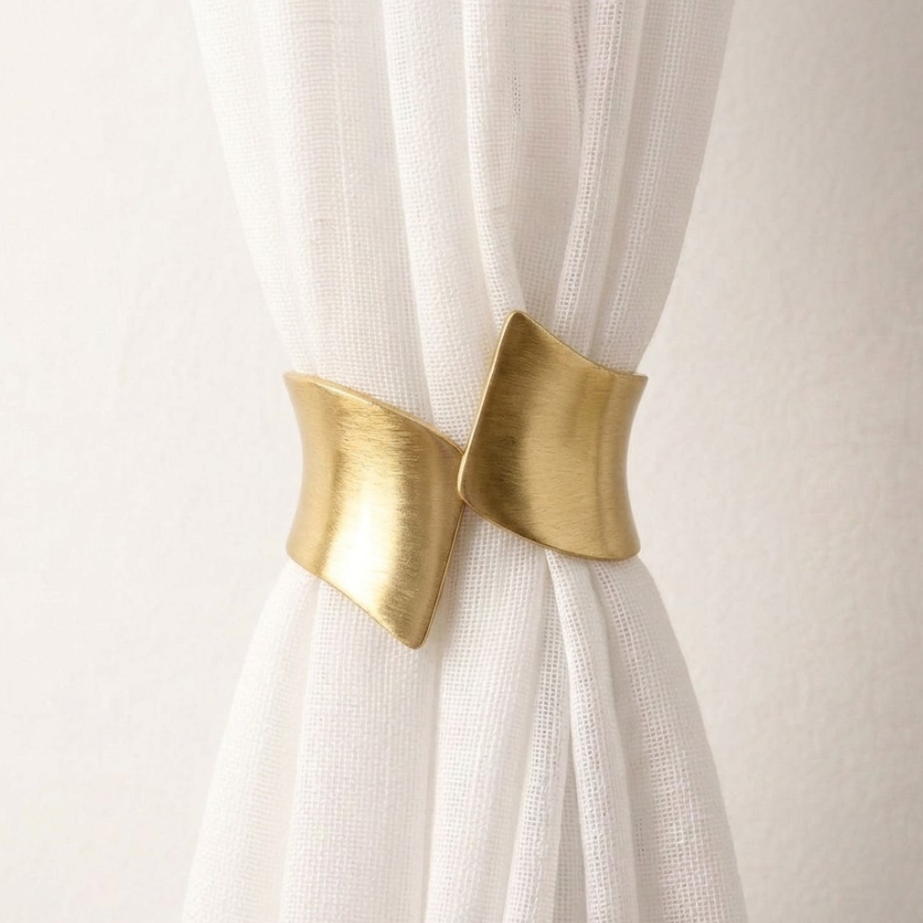White curtain with gold curtain tiebacks on a white background