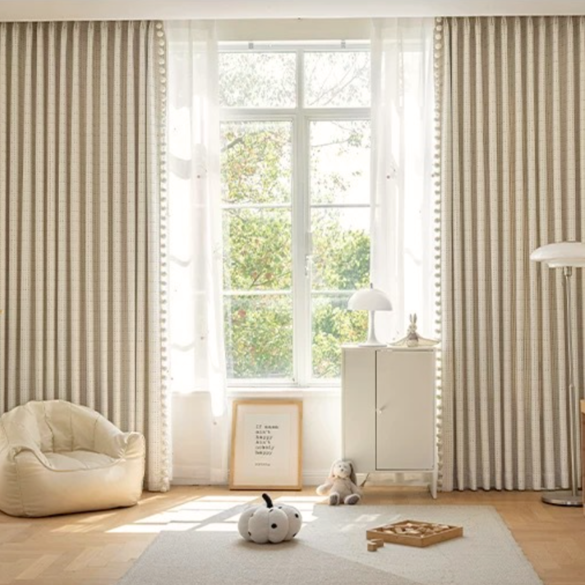 Children's room with rainbow dotted curtains, a chair, and toys on a rug.