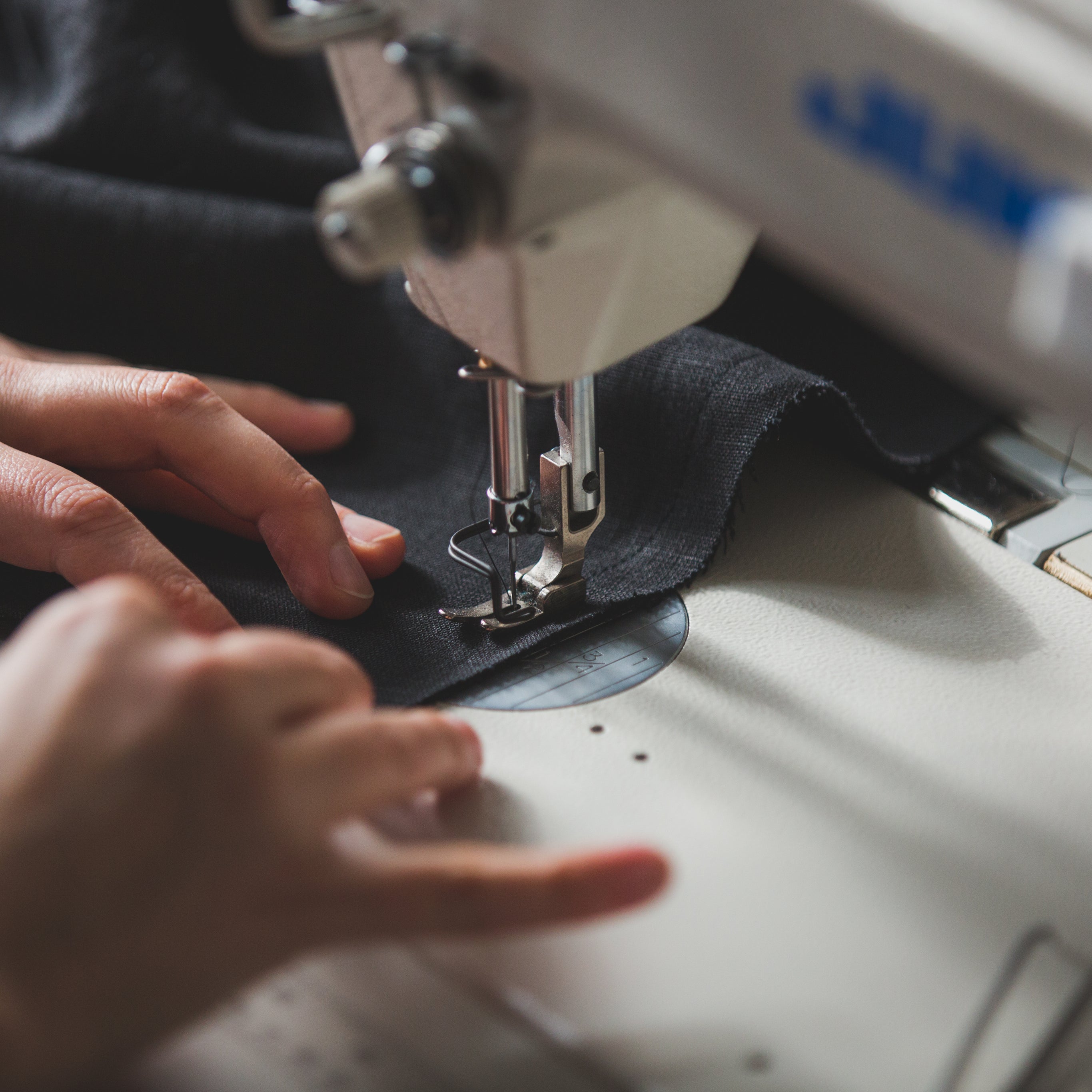 tailor using sewing machine