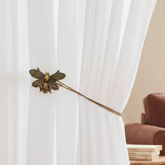 Brown leather sofa with a white blanket in a room with white curtains and a wooden side table.