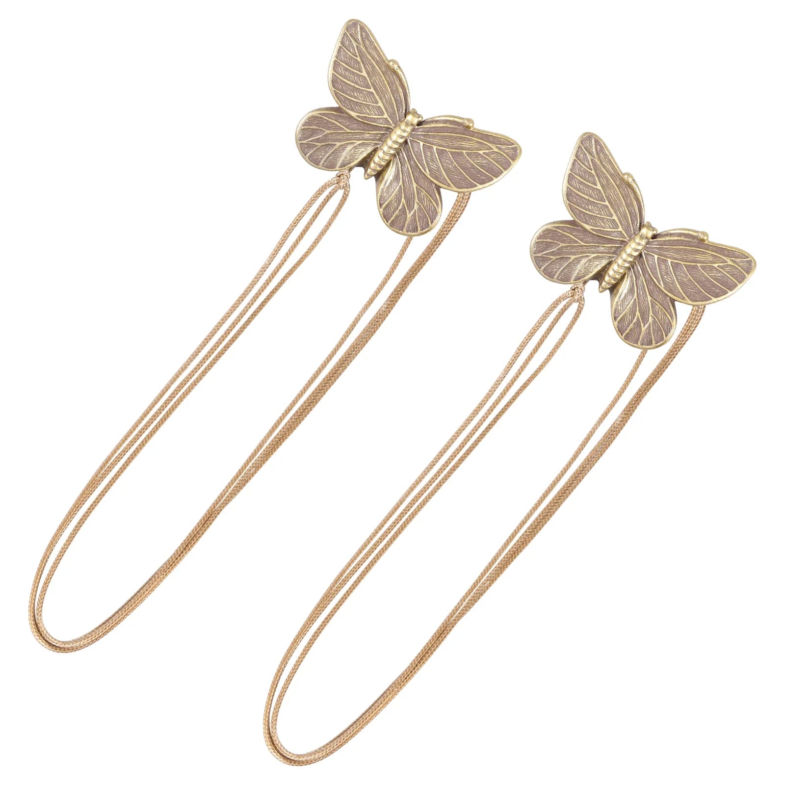 Butterfly-shaped bronze curtain tiebacks on a white background