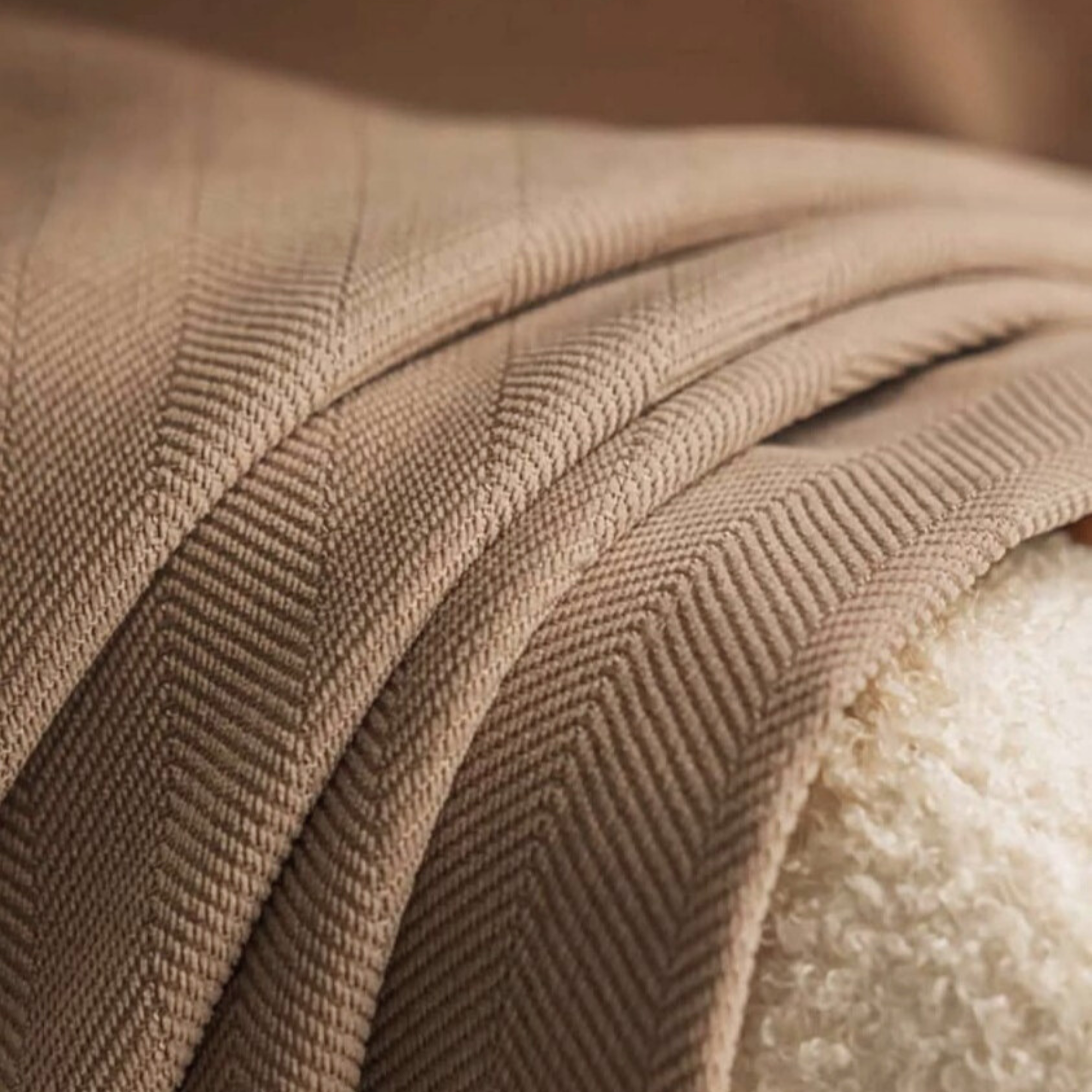 Close-up of a textured brown fabric with a blurred background