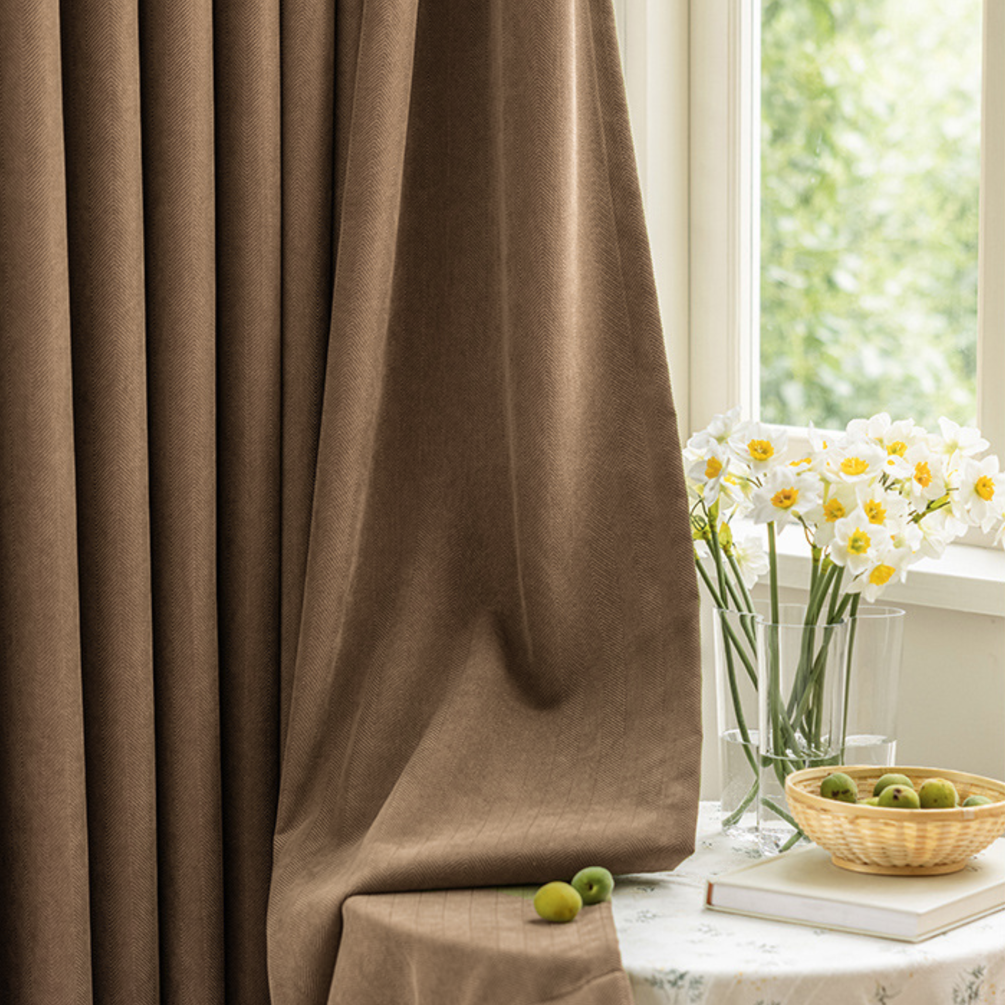 Brown curtain with a table and flowers in the background
