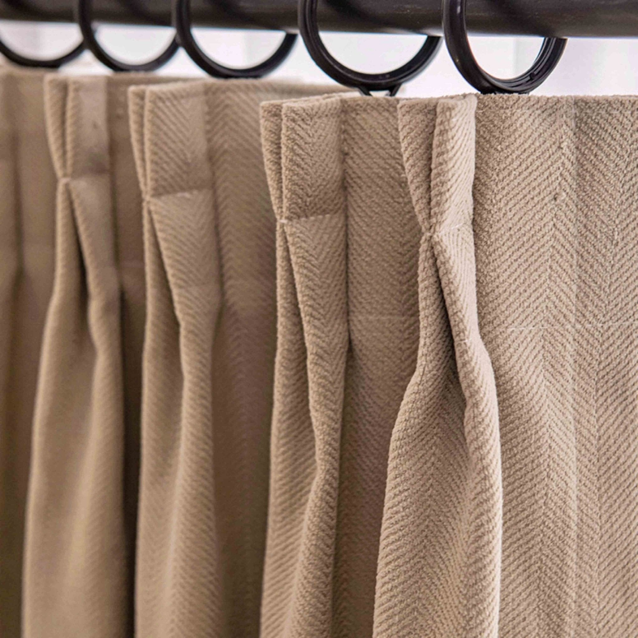 Beige herringbone textured curtain with pinch pleats