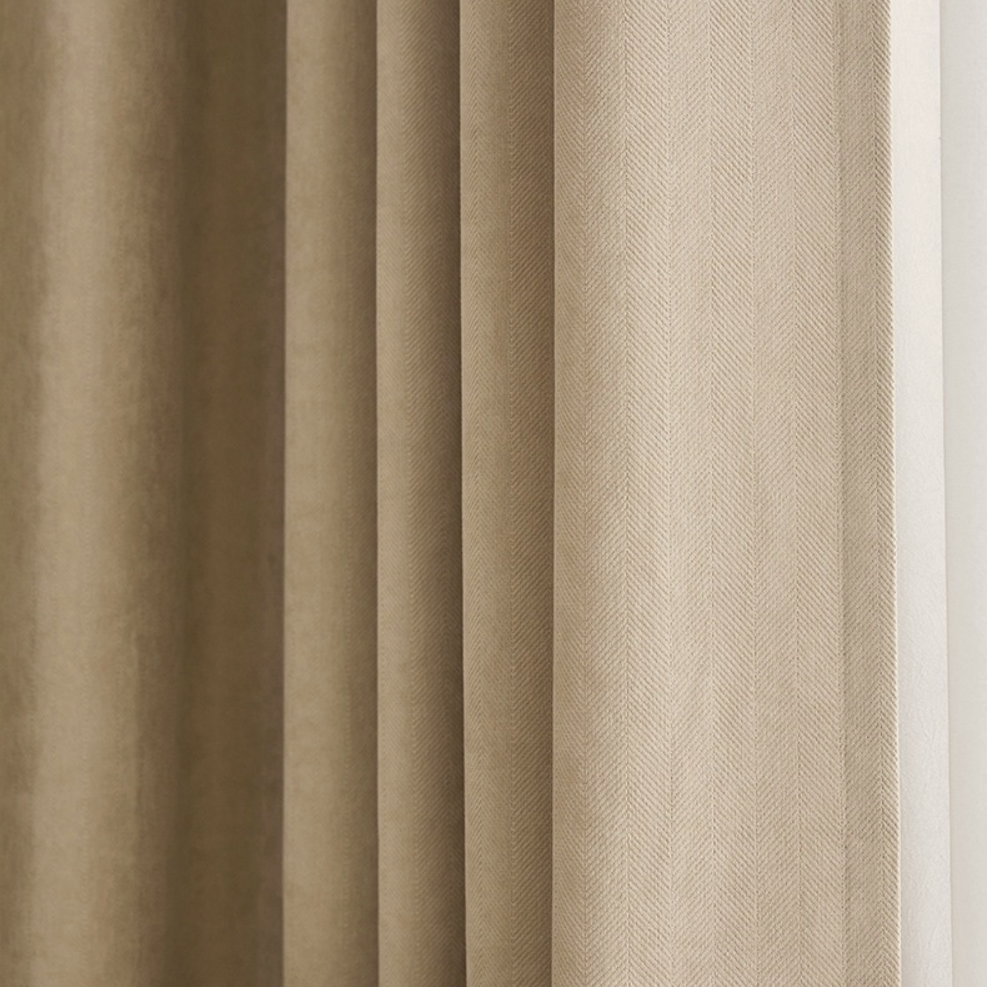 Close-up of herringbone textured curtains in beige