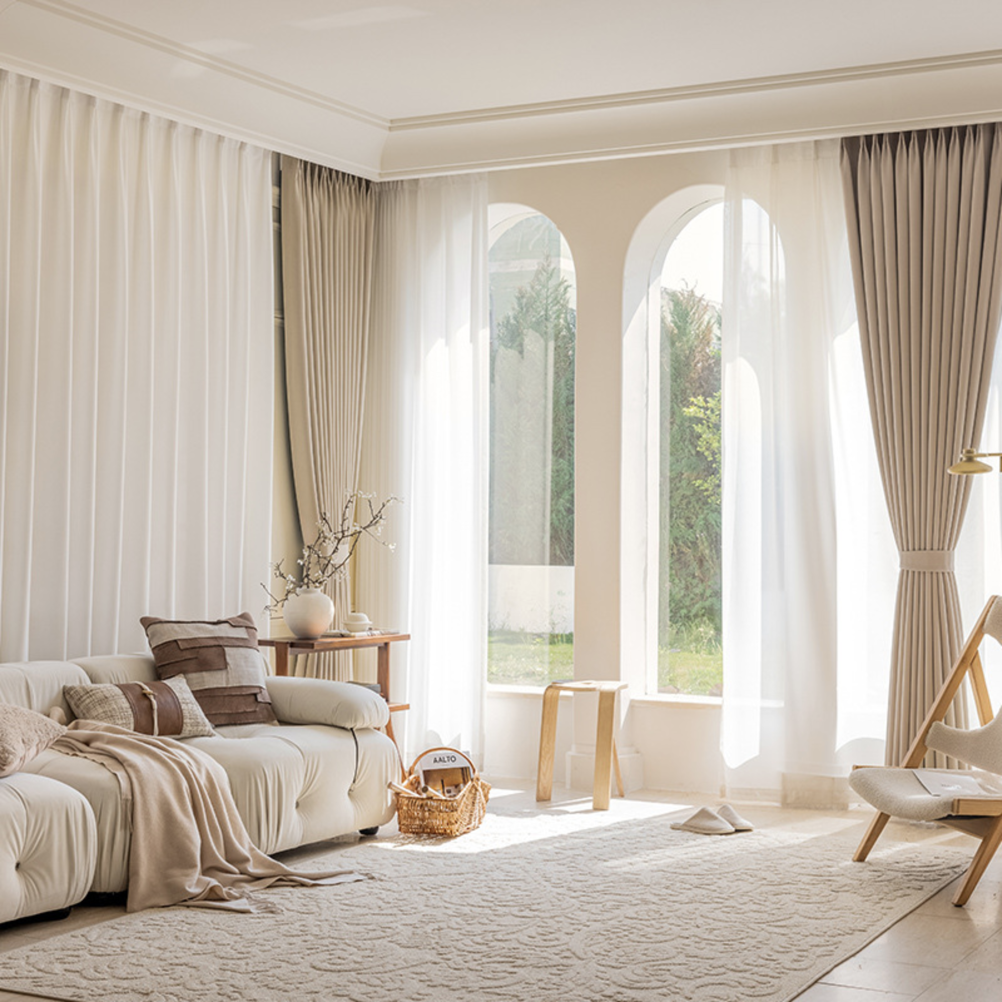 Living room with beige sofa, decorative pillows, and large windows with beige herringbone curtains.