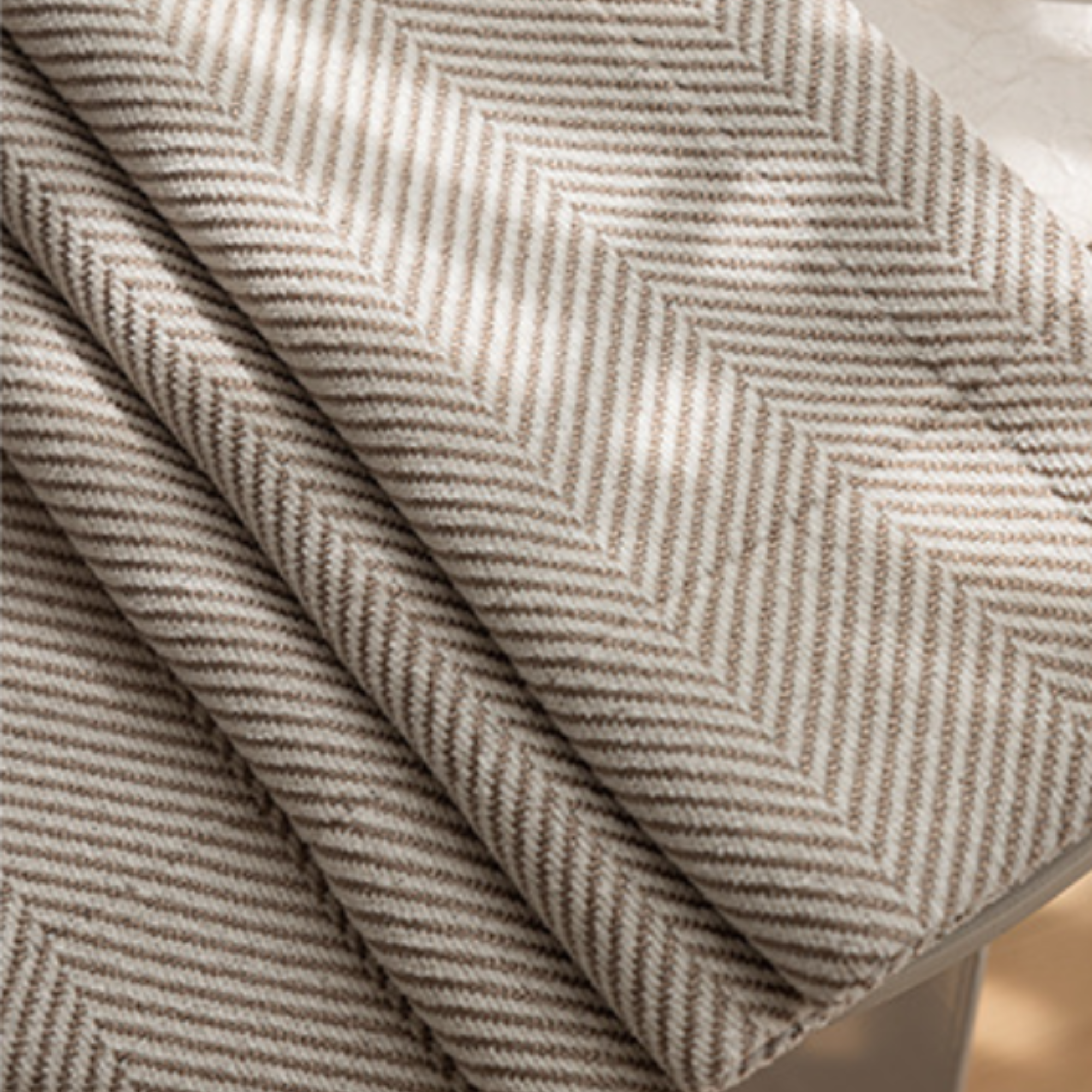 Close-up of textured fabric with a herringbone pattern