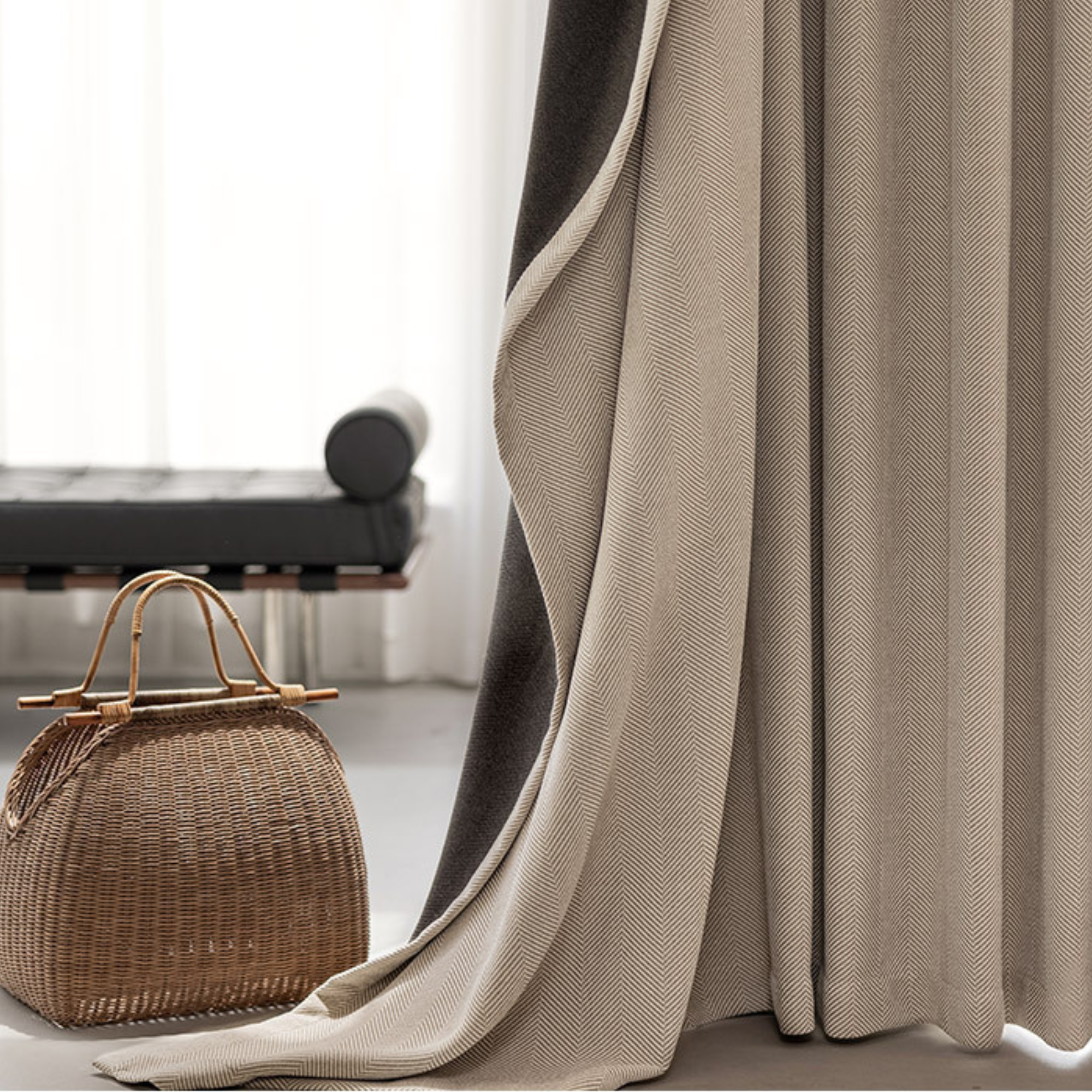 herringbone curtain with a woven handbag on a light background