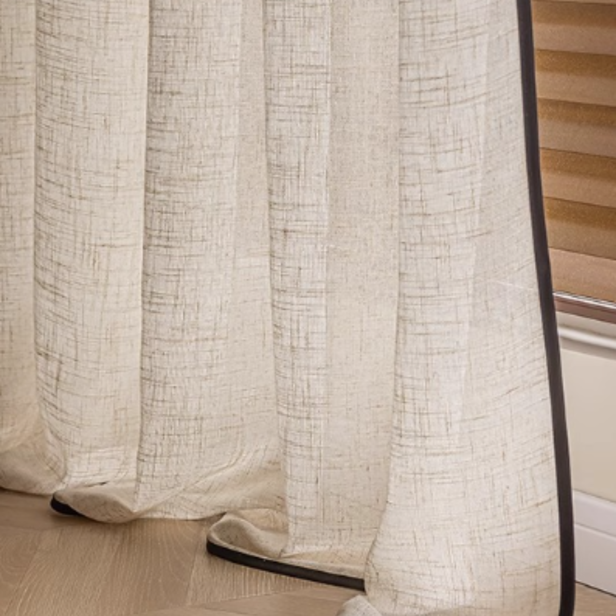 Close-up of custom linen sheer curtains with bold black trim, showcasing a light filtering fabric and sophisticated design, perfect for modern interiors.