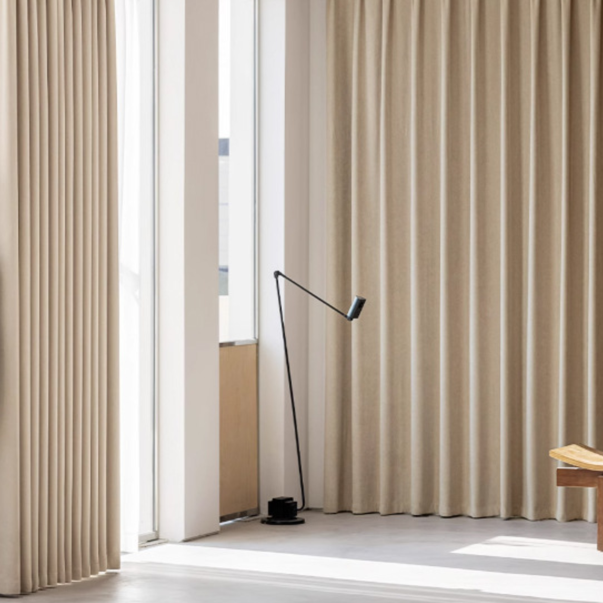 Beige blackout curtains in a room with a floor lamp and chair.
