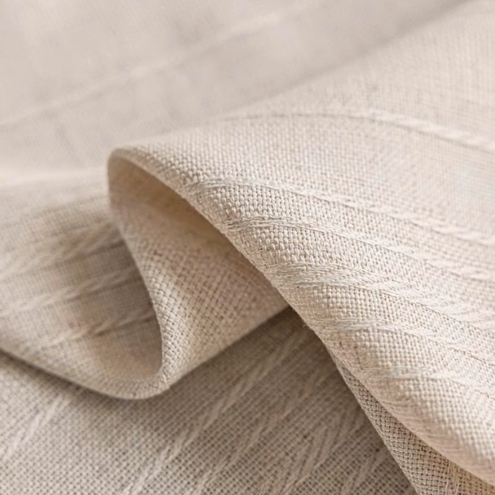 Close-up of beige textured linen curtain fabric