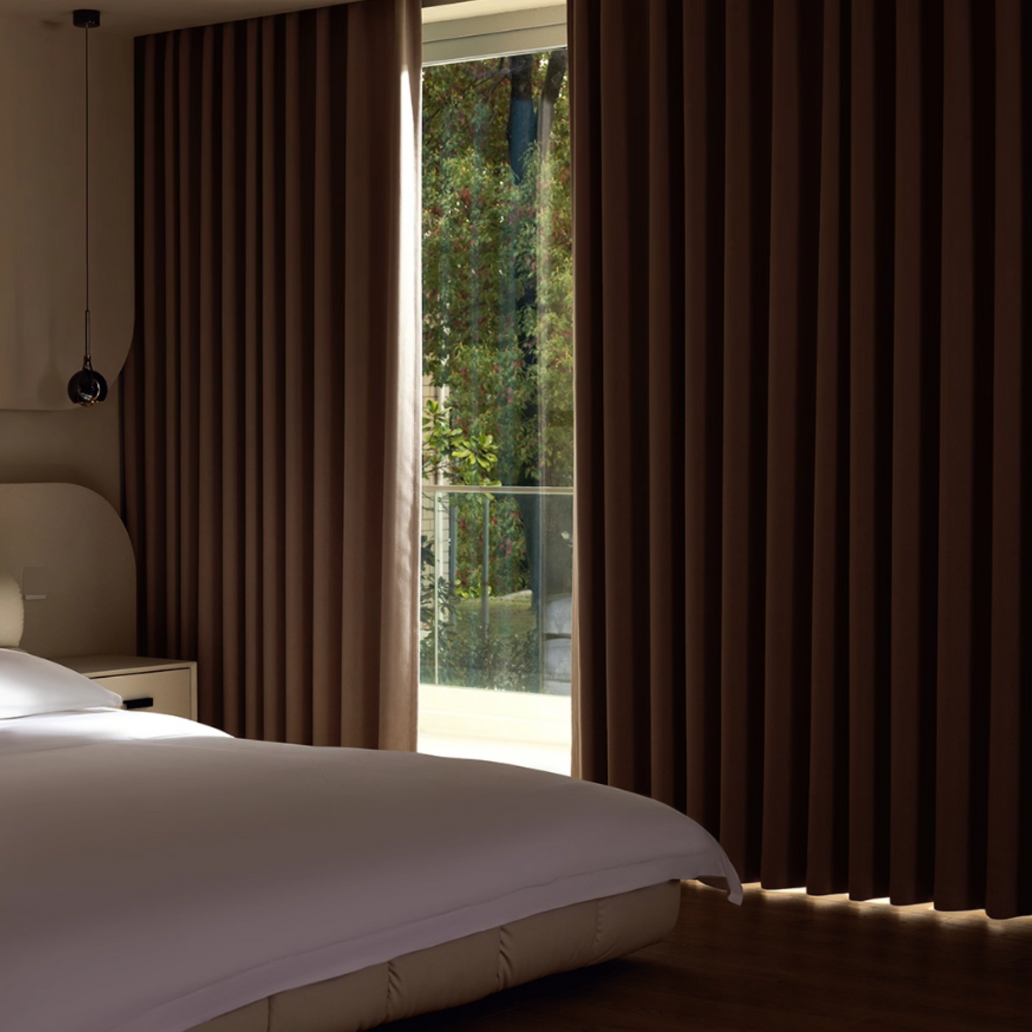 Bedroom with cream colored blackout curtains,showing the light blocking effect during the day