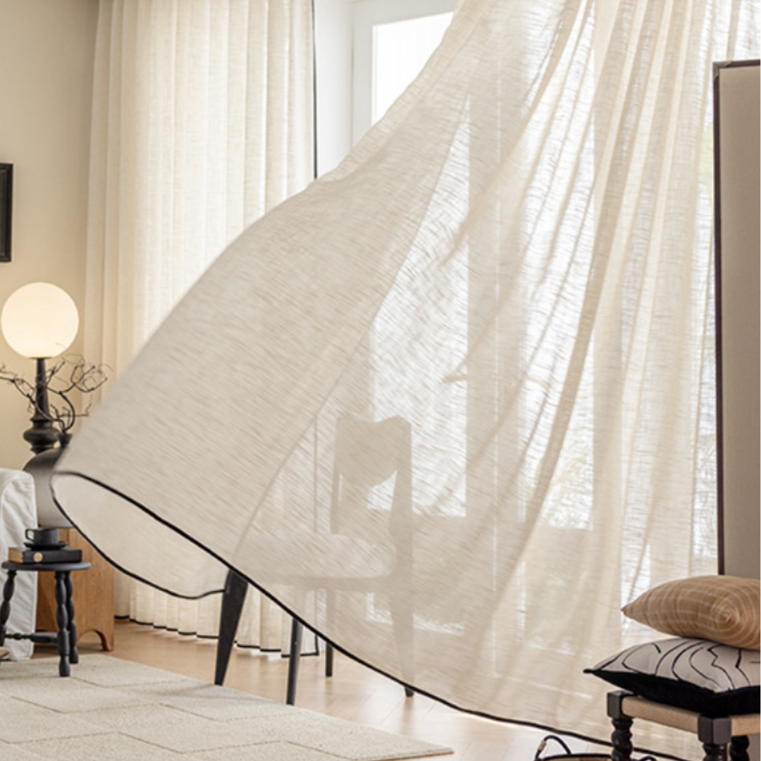 Sheer linen curtains in a living room with furniture and decor, showcasing how its light filtering effect.