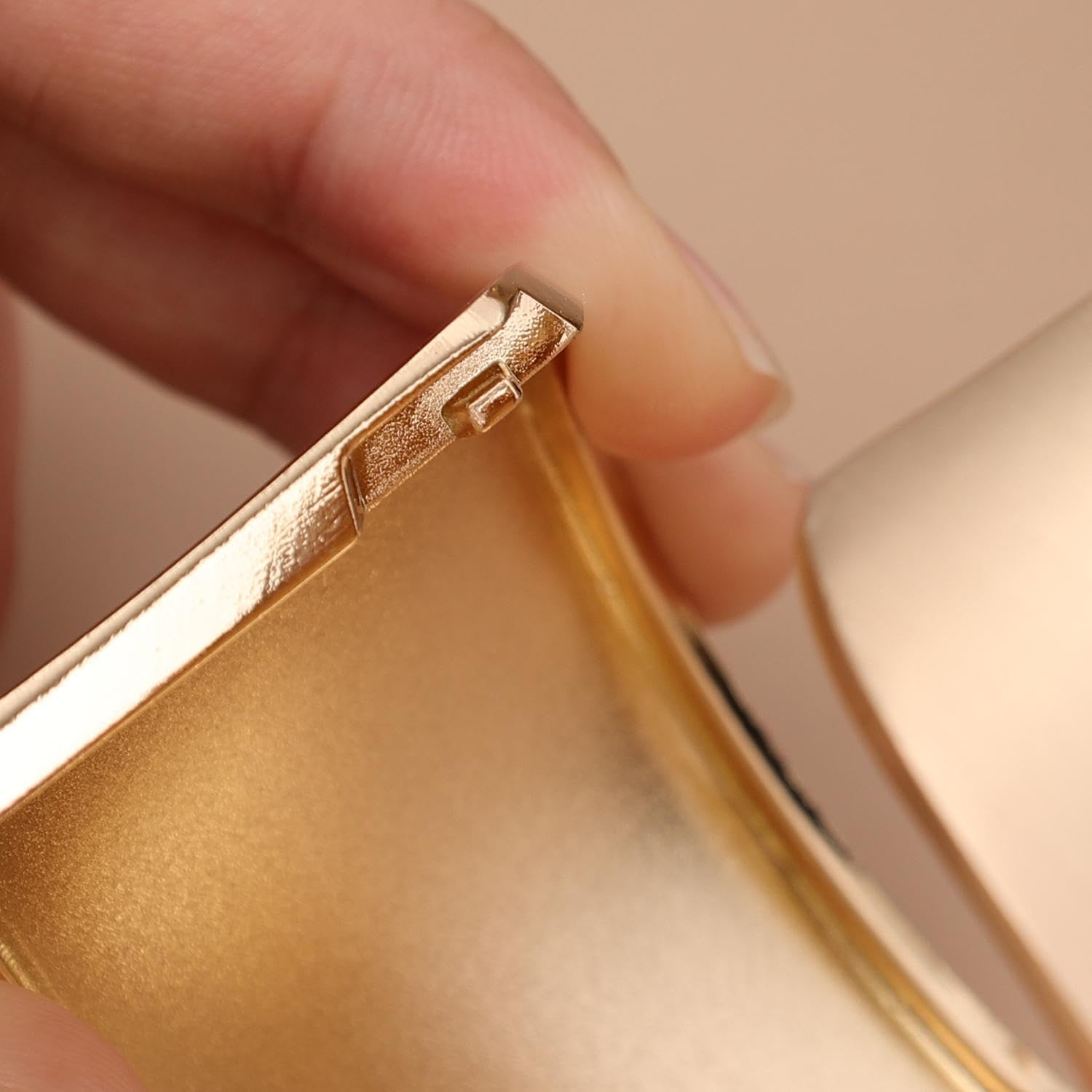Close-up of a hand holding a Brushed Gold Curtain Tieback