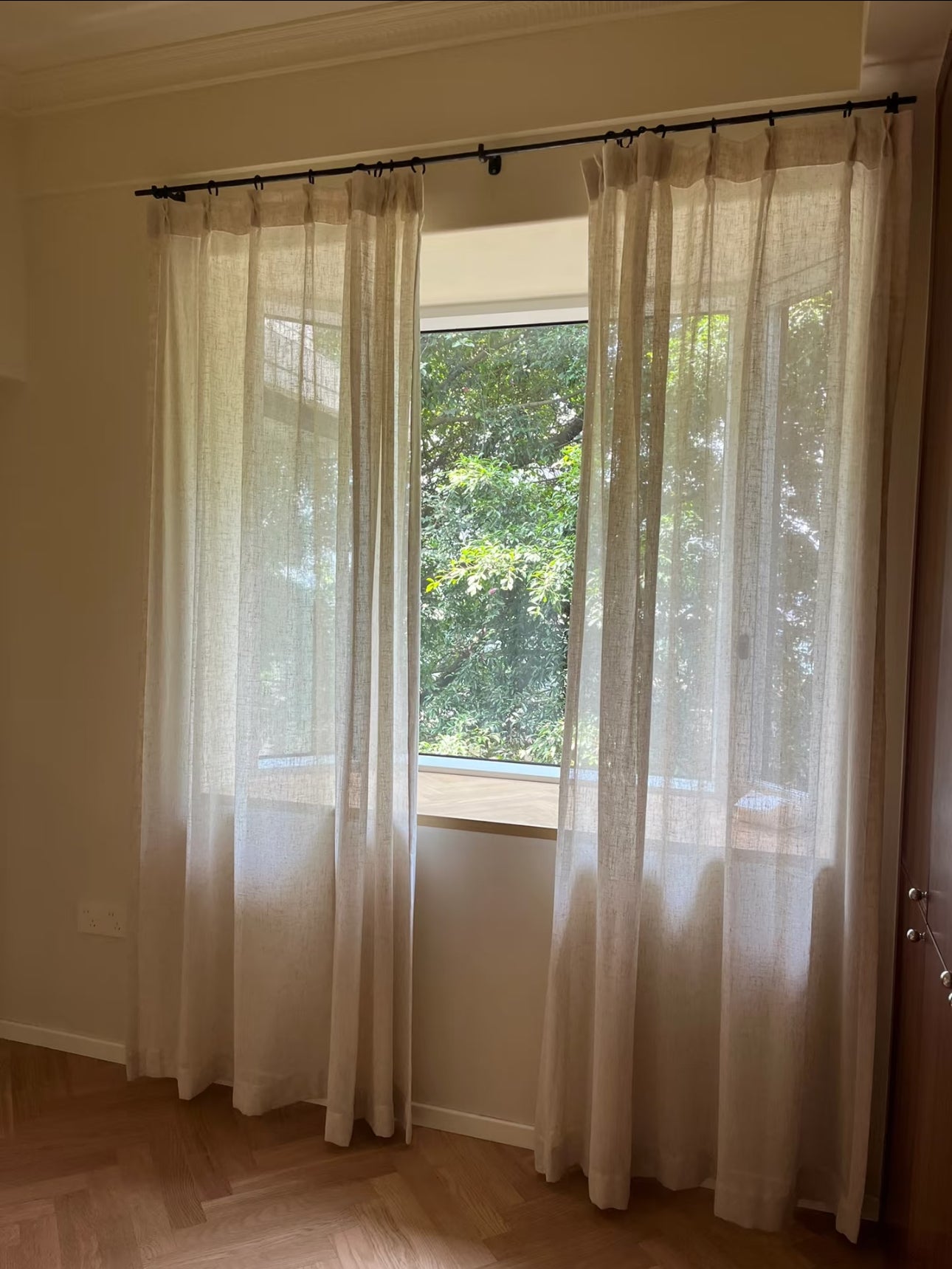 Linen sheer curtains in front of bay windows