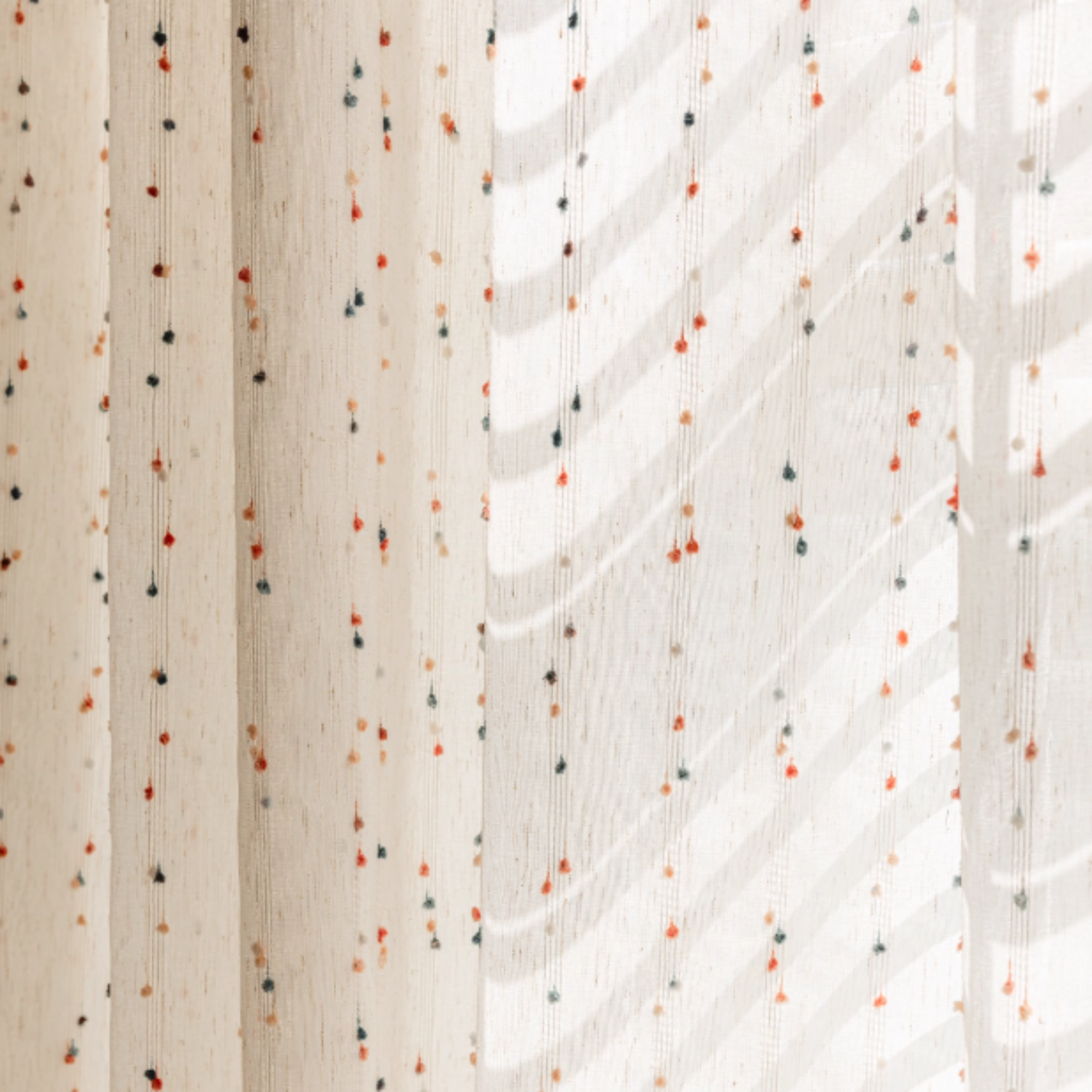 Textured beige linen fabric with small colorful dots