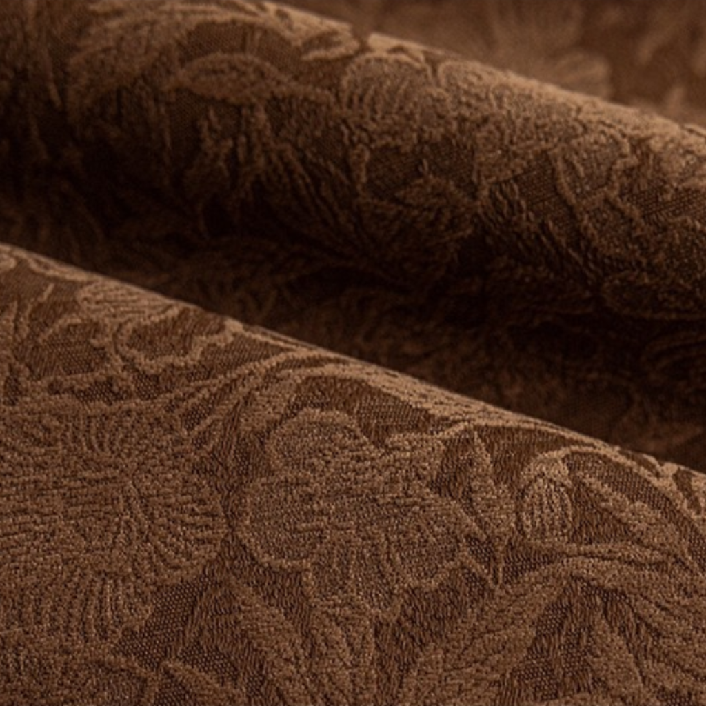 Close-up of brown textured fabric of blackout curtains for bedroom with a subtle floral pattern