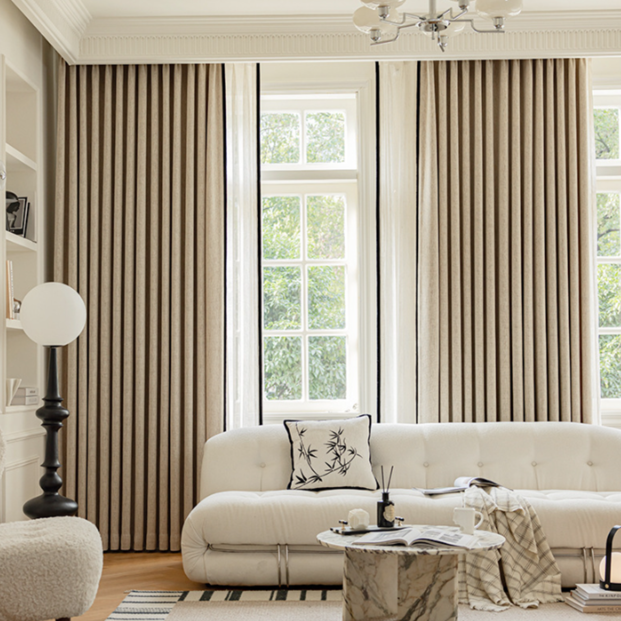 Living room with custom beige room darkening curtains, white sofa, and marble coffee table.