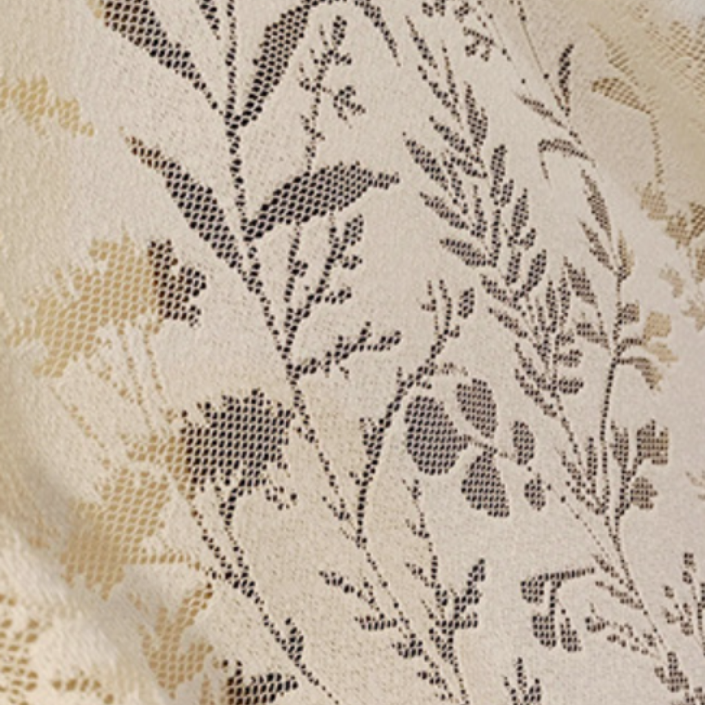 Cream floral lace curtain fabric closeup shot