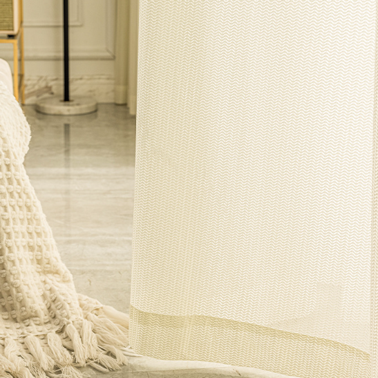 Durable and stylish cream colored sheer curtains, designed to be cat-proof and ideal for cat owners.