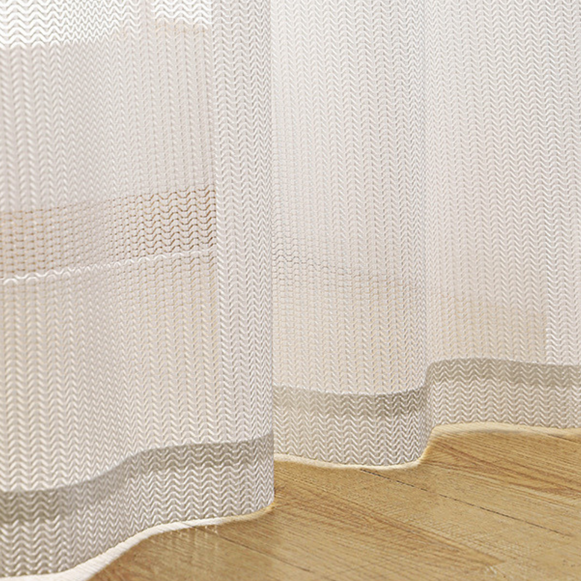 Cat proof white curtains with a wooden floor in the foreground