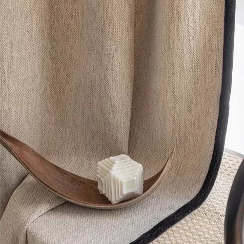 Modern cream-colored custom room darkening curtains for your bedroom, creating a cozy atmosphere.