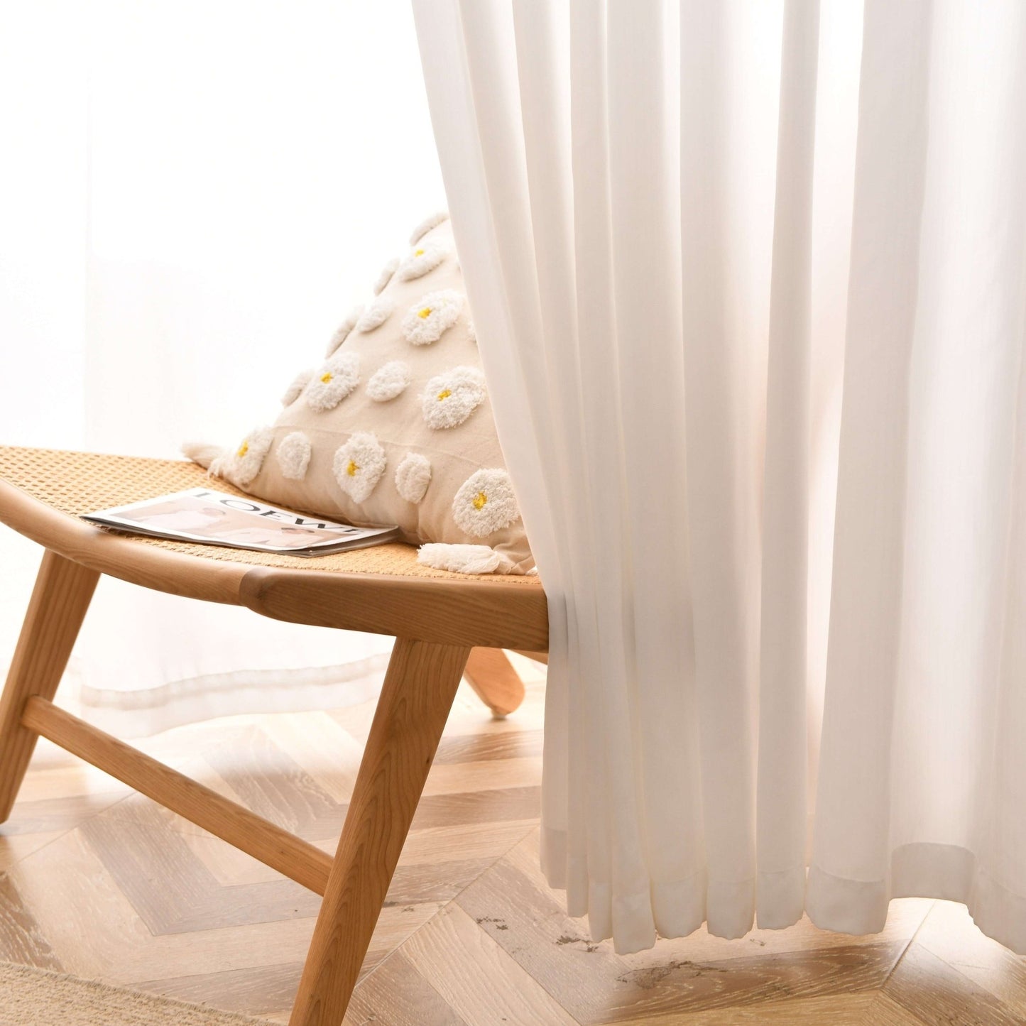 Opaque privacy sheer curtains covering part of a chair.