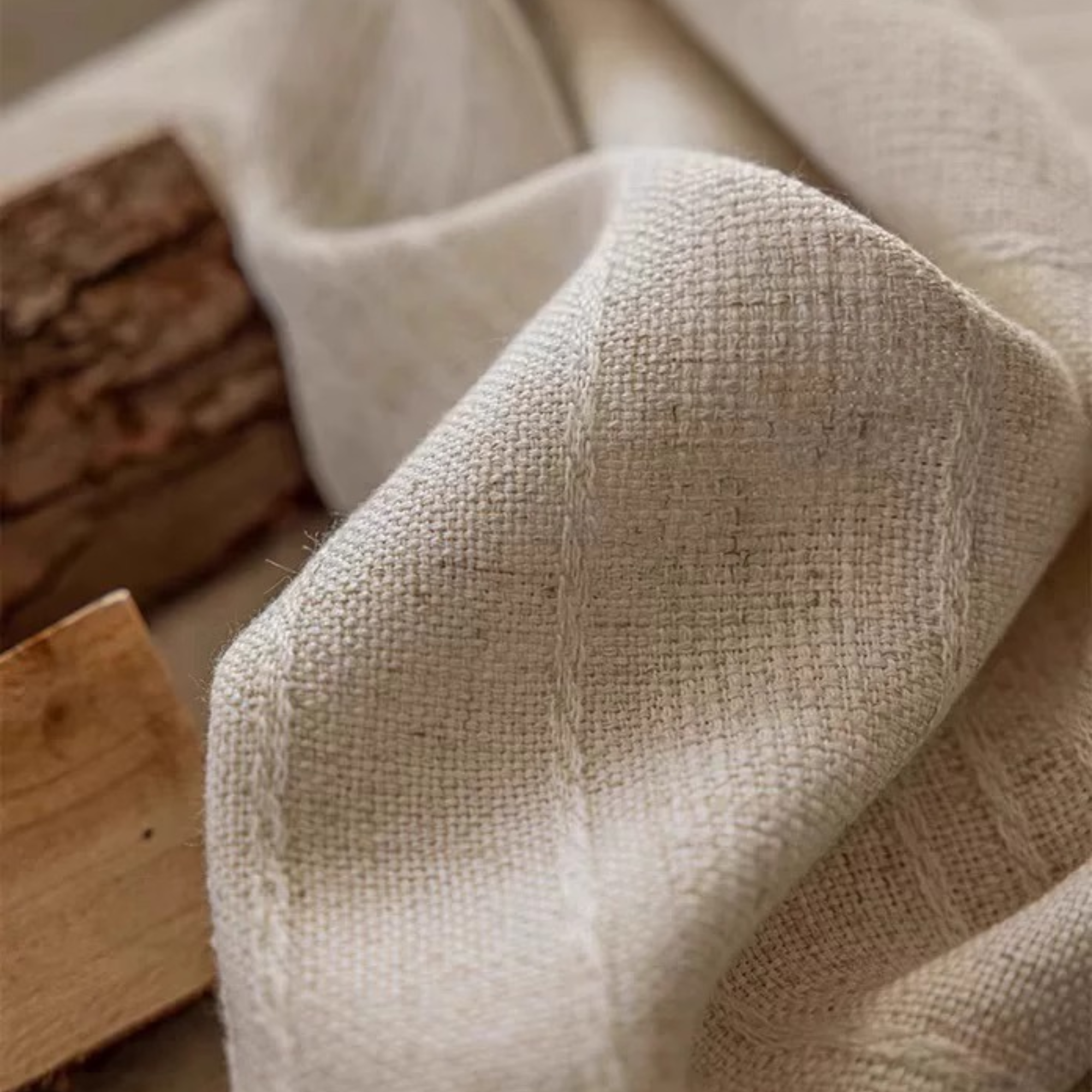 Close-up of beige linen curtain fabric with with striped weaving details