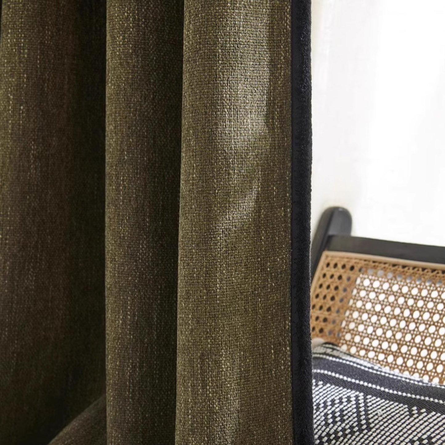 Close-up of stylish olive green living room curtains with black rim