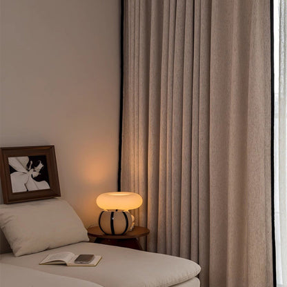 room darkening curtains in cream, hanging in a bedroom window, providing privacy and style.