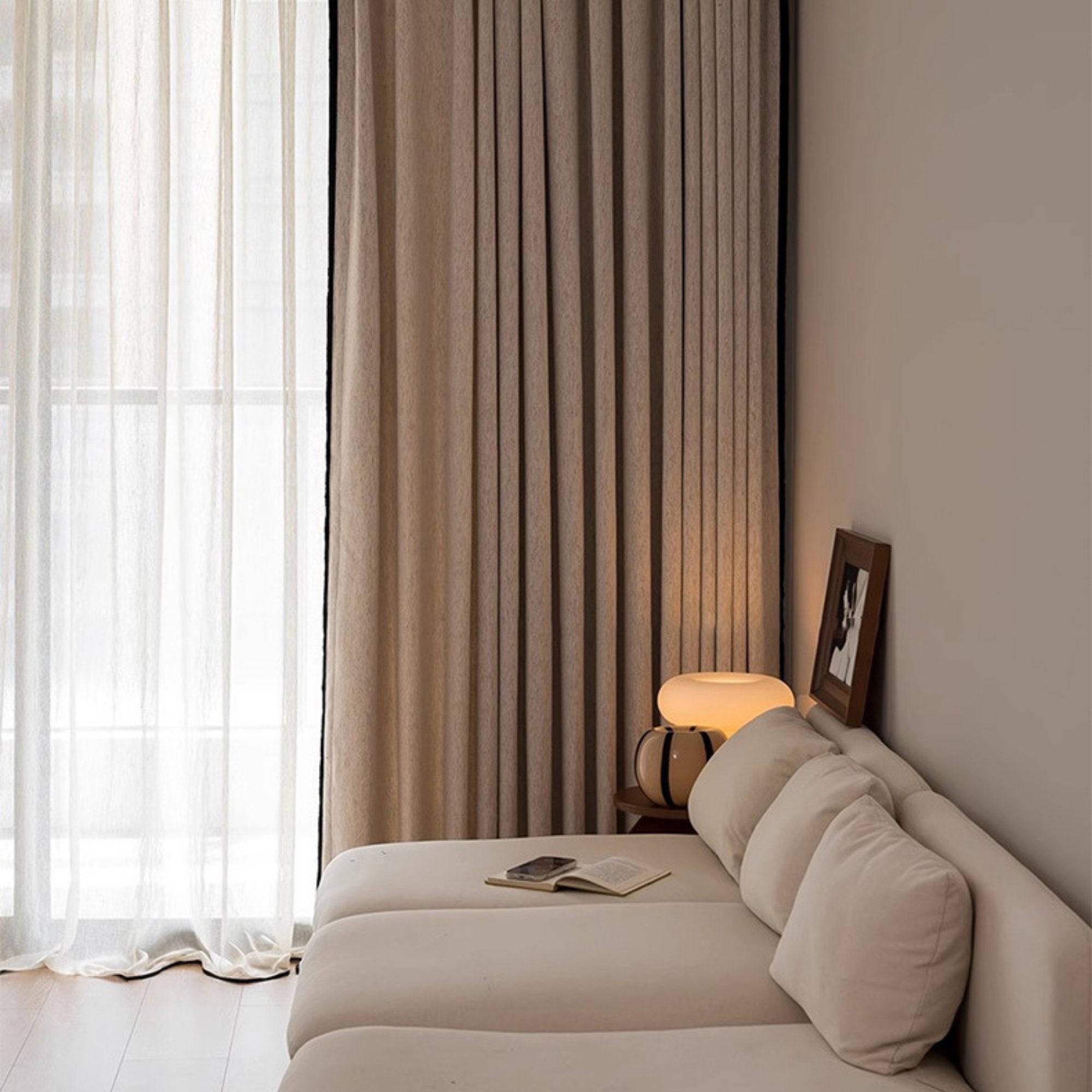 Luxurious cream-colored custom living room curtains with room darkening properties, paired with linen sheer curtains.