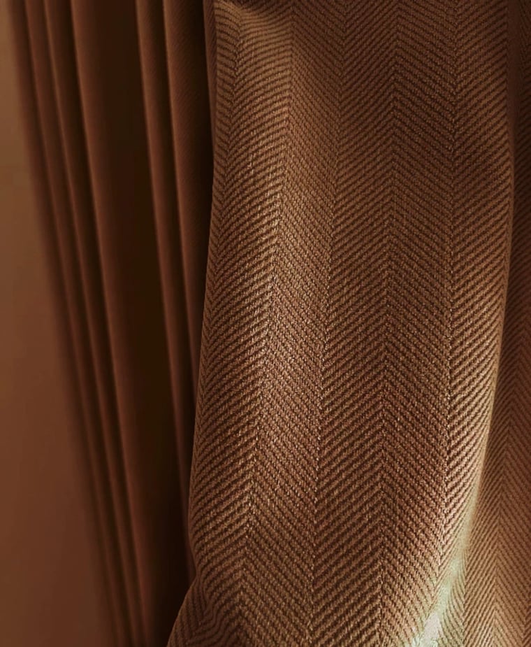 Close-up of brown fabric with a herringbone pattern
