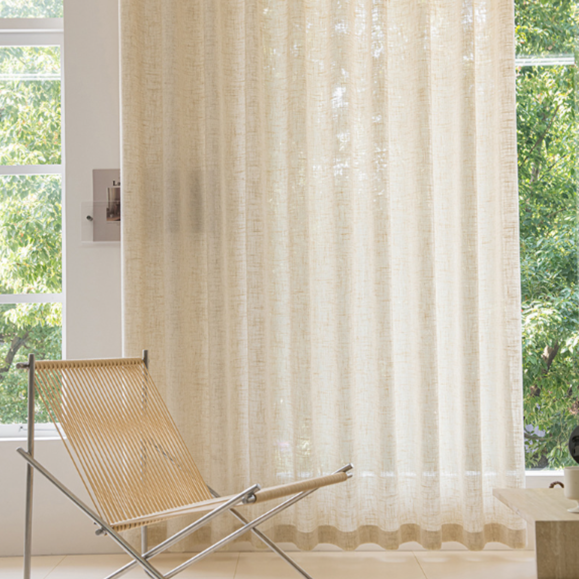 Floor-length linen sheer curtains in living room, creating an elegant drape.