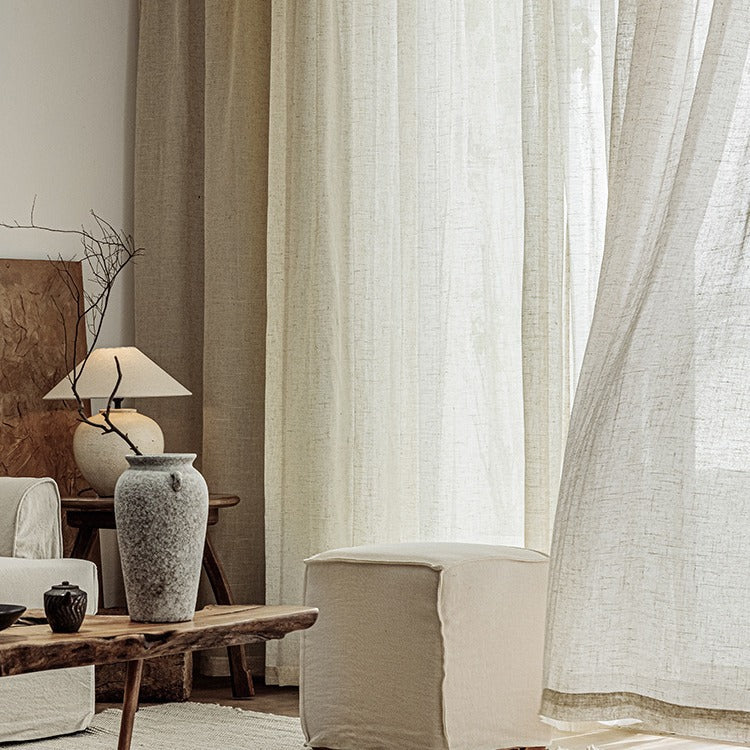 Living room with linen sheer curtains allowing soft, natural light to filter through.