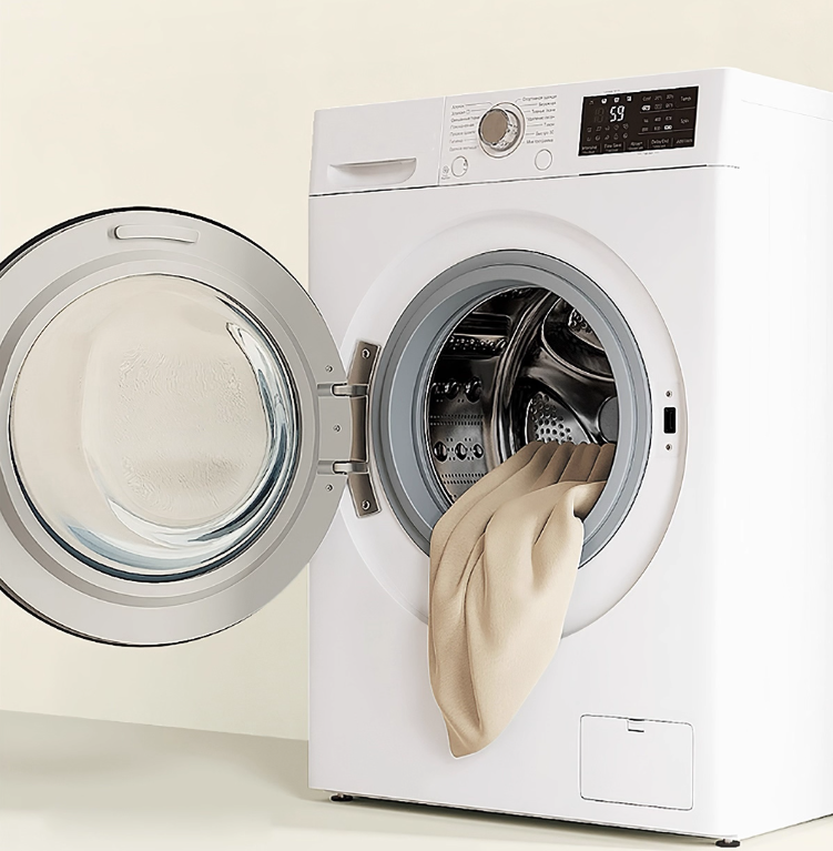 White washing machine with open door showing a beige curtain inside on a light beige background