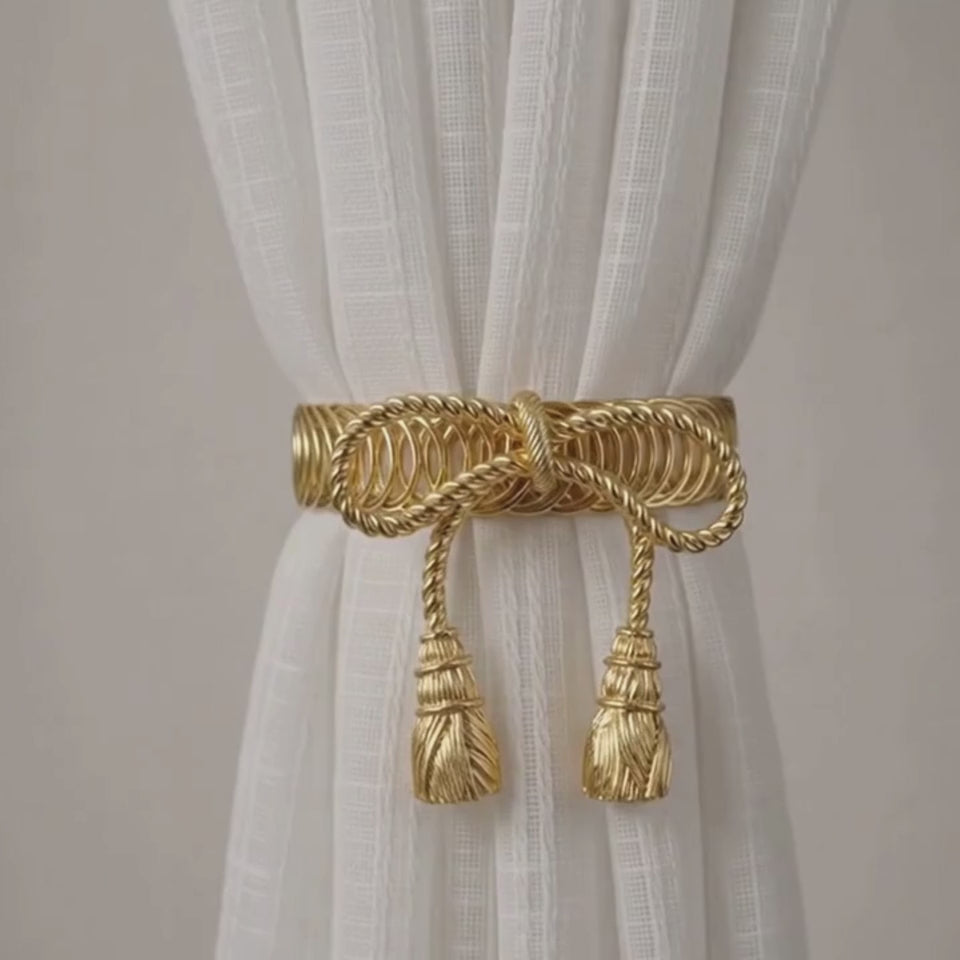 different angles of the gold rope bow tieback with tassels