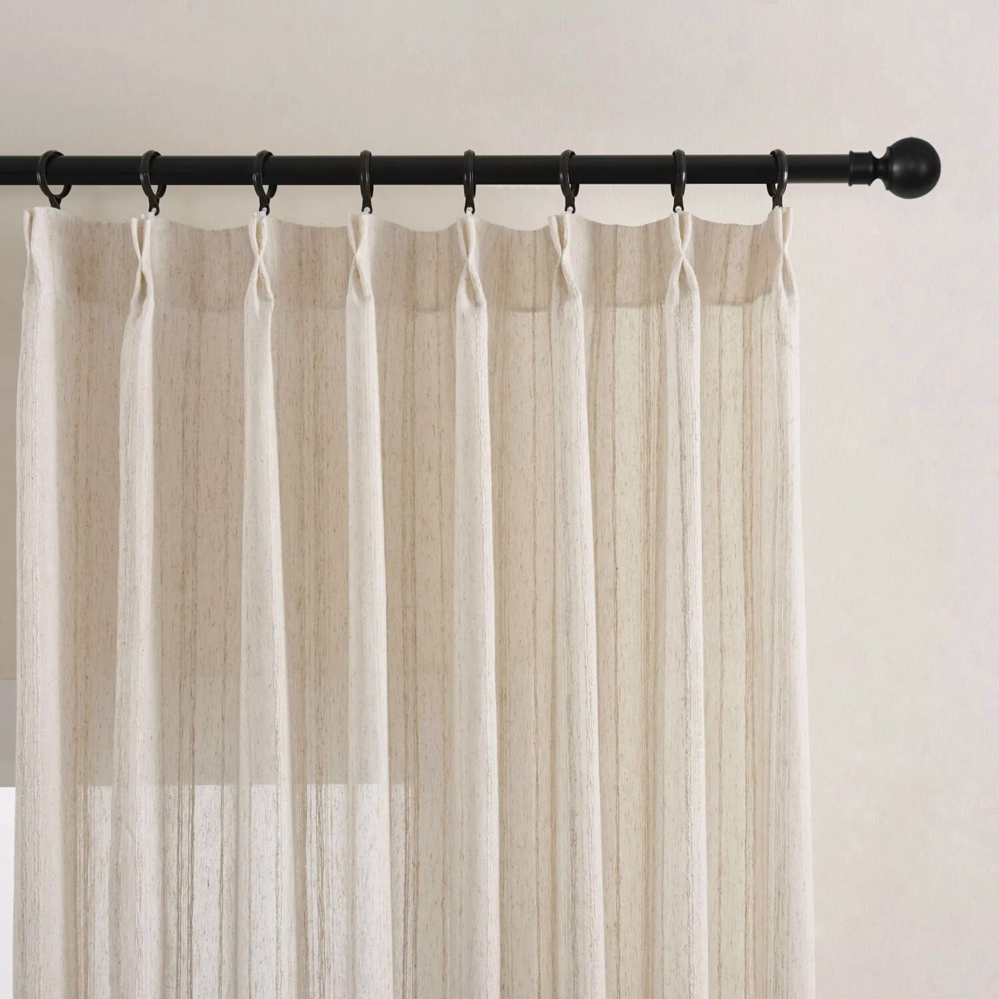 woven striped linen sheer curtains with pinch pleated heading style on a black curtain rod